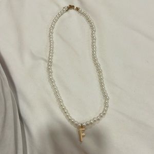 Pearl necklace letter F